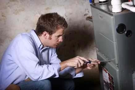 Trusted HVAC Professionals - Technician performing an inspection on a heating & air conditioning system