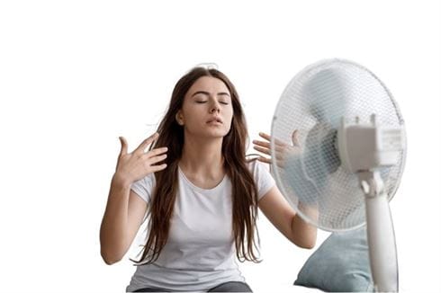 Professional Services in College Park, Georgia - College Park, Georgia woman in front of a fan and trying to cool off while waiting for the AC technician from Reynaud HVAC to arrive.